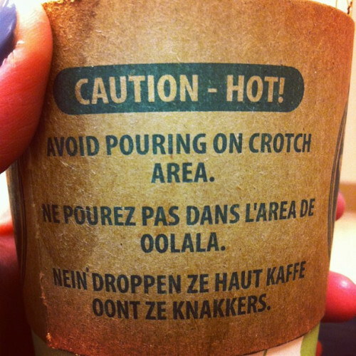 A coffee cup with the worst French and German writing on the side is