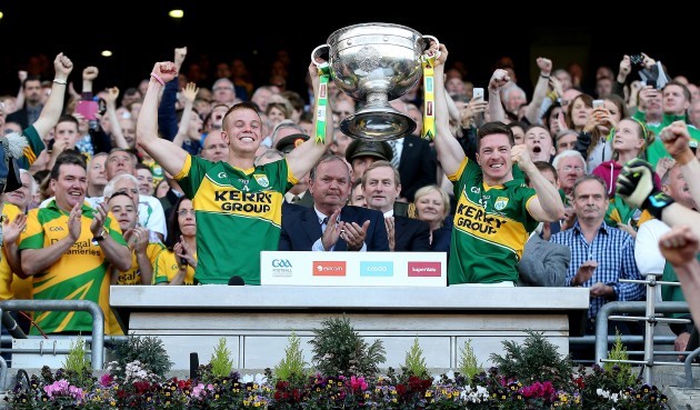 Fionn Fitzgerald and Kieran O'Leary lift the Sam Maguire trophy