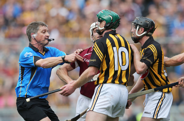 Barry Kelly attempts to separate Andy Smith and Henry Shefflin