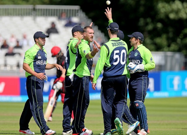 John Mooney celebrates with team mates after taking a wicket