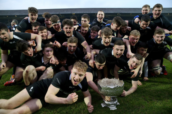 The Roscrea players celebrate with the cup