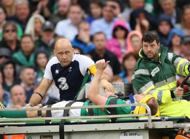 Keith Earls signals to the crowd as he goes off injured