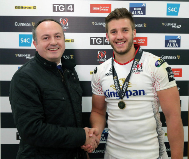 Stuart McCloskey is presented with the Man of the Match award by Colin Bell