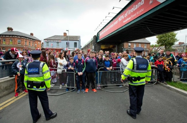 Fans wait to enter the stadium