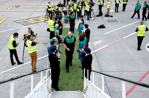 Aer Lingus staff members show their ‘Green Spirit’ as they get behind the Irish rugby team for their final send off at Dublin Airport