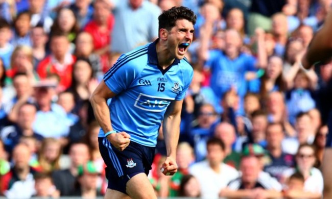 Bernard Brogan celebrates scoring a point despite the efforts of Colm Boyle