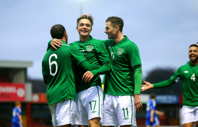 Jack Grealish celebrates scoring his side's third goal with Samir Carruthers and Anthony Forde