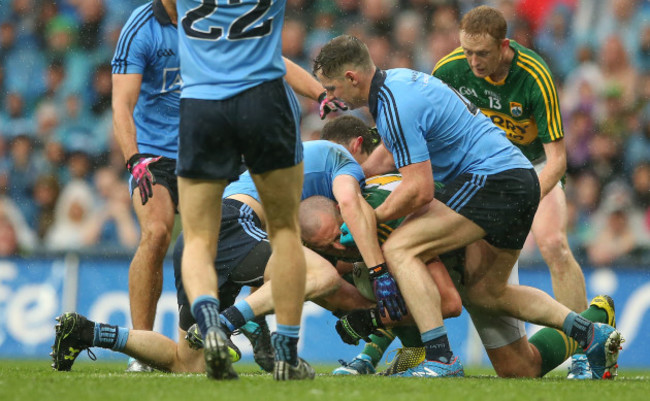 Rory O'Carroll and Philly McMahon tackle Kieran Donaghy