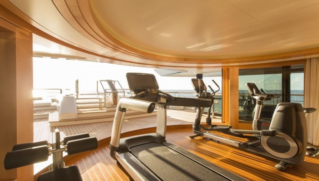 the-boat-includes-a-gym-with-state-of-the-art-equipment-that-has-a-stunning-view-out-onto-the-bow-of-the-vessel-a-giant-sliding-door-reveals-the-outside-and-can-let-a-breeze-in-the-area-leads-into-the-pool-if