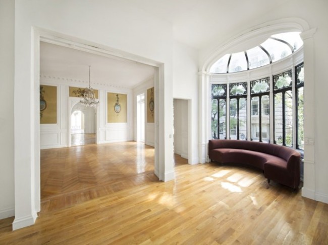 windows-drench-the-house-in-sunlight-while-providing-a-view-of-the-tree-lined-streets