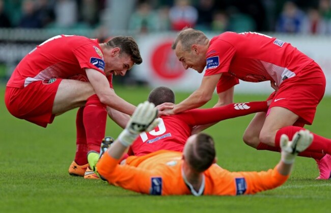 Karl Sheppard and Garry Buckley congratulate Danny Morrissey after he scored the opening goal