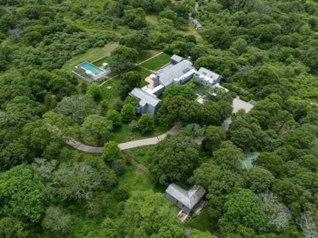 a-private-driveway-leads-to-the-estate-which-includes-a-half-basketball-court-and-a-dock-and-access-to-three-private-beaches