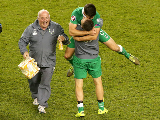 Robbie Keane greets Shane Long with Dick Redmond