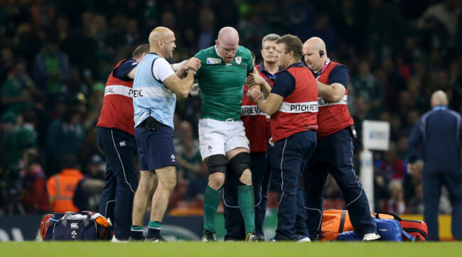 Paul O'Connell tries to get to his feet before being stretchered off the field