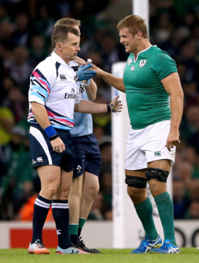 Nigel Owens checks on Chris Henry