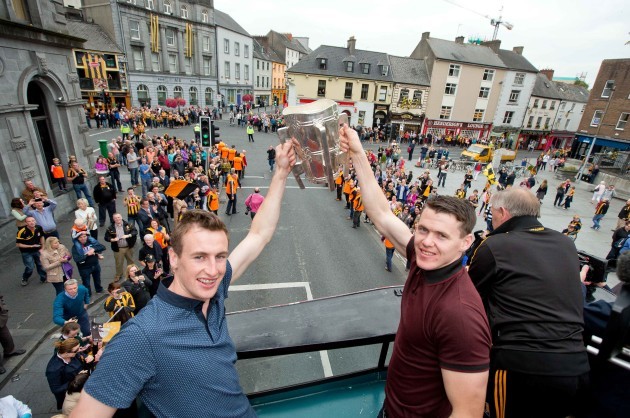 Joey Holden and TJ Reid show the Liam McCarthy Cup to supporters