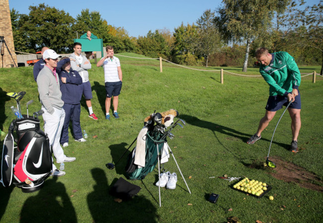 Rory McIlroy shares a joke with the Irish players as Luke Fitzgerald duffs a tee shot