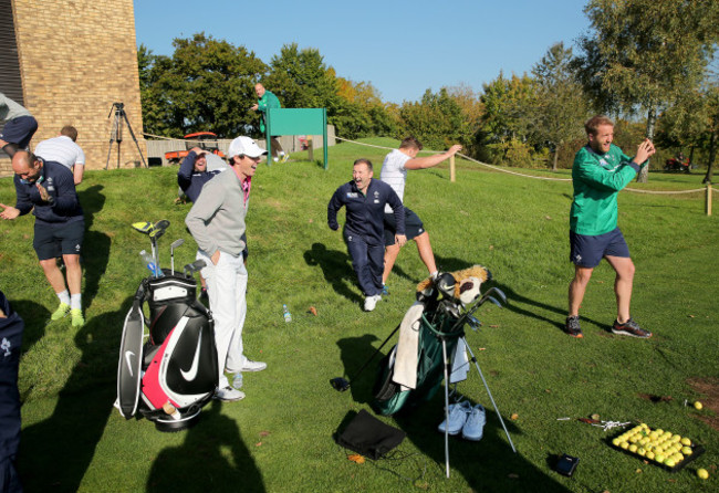 Rory McIlroy shares a joke with the Irish players as Luke Fitzgerald duffs a tee shot