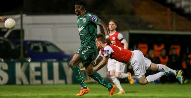 Ian Morris clears the ball under pressure from Ismail Akinade