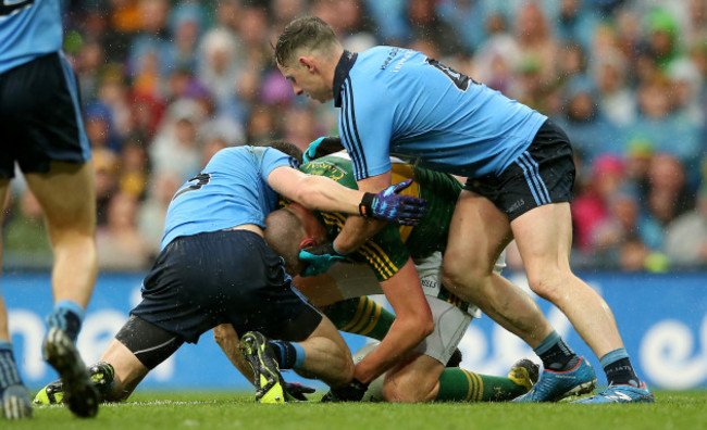 Rory O'Carroll and Philly McMahon tackle Kieran Donaghy