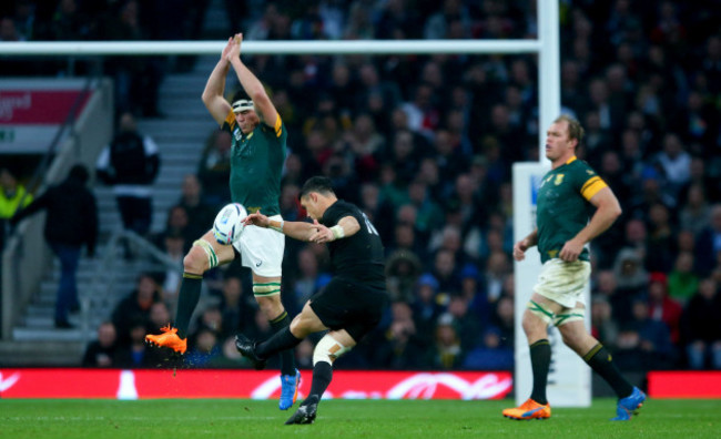 Daniel Carter kicks a drop goal