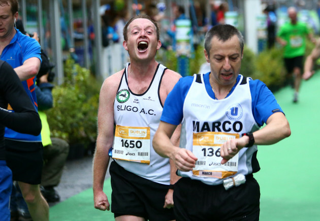 A competitor reacts after finishing the Dublin City Marathon