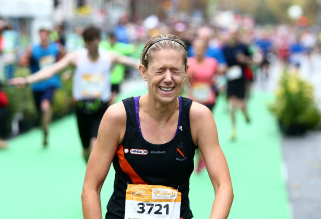A competitor reacts after finishing the Dublin City Marathon
