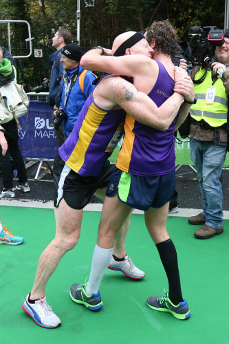 Competitors embrace after finishing the Dublin City Marathon
