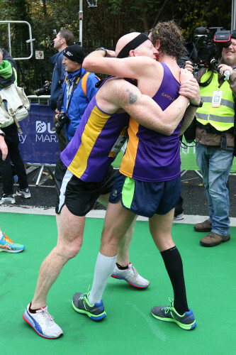 Competitors embrace after finishing the Dublin City Marathon