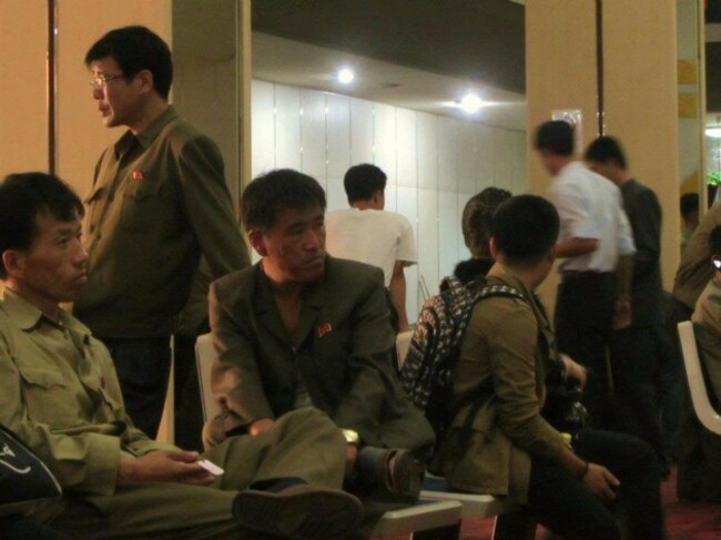 they-were-then-escorted-to-the-golden-lane-bowling-alley-the-pins-pictured-on-the-shirts-of-the-men-here-are-loyalty-badges-emblazoned-with-the-image-of-the-dear-leaders-face-justin-and-anna-were-told-that-th