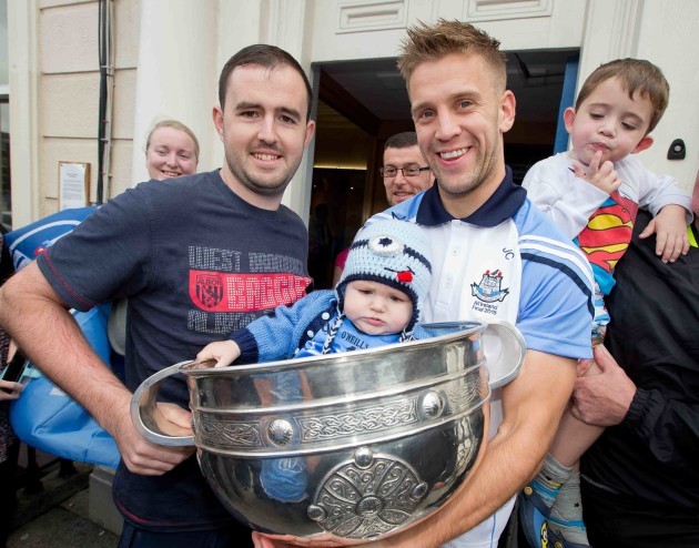 Jonny Cooper with the Sam Maguire trophy meets Evan Egan and his father Gary Egan