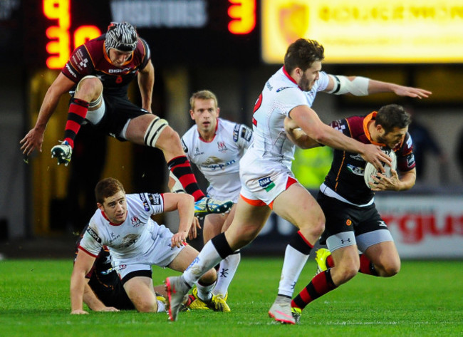 Jason Tovey is tackled by Stuart McCloskey