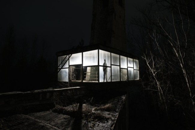 here-de-rueda-poses-for-a-self-portrait-inside-an-abandoned-bus-station-near-the-pripyat-cafe