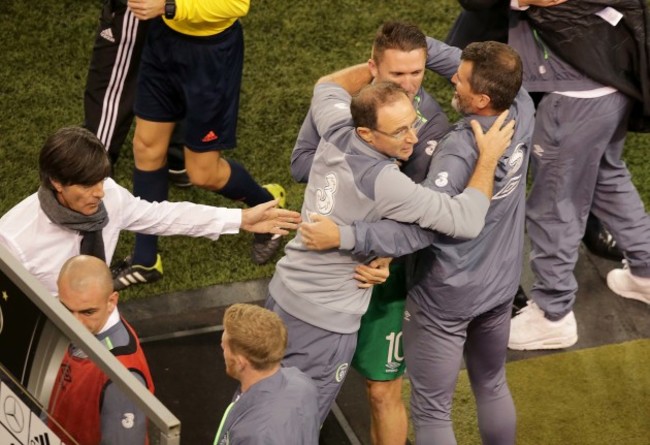 Martin O'Neill, Robbie Keane and Roy Keane celebrate the final whistle as Joachim Low congratulates them