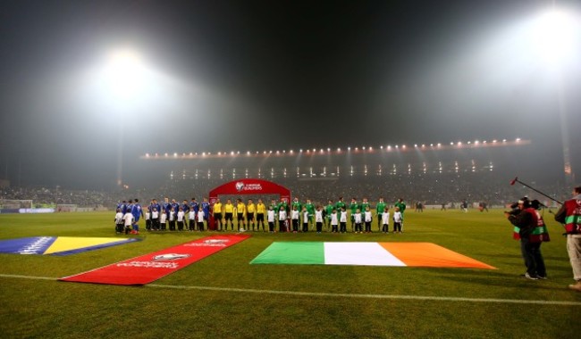 The two teams stand for the National Anthems