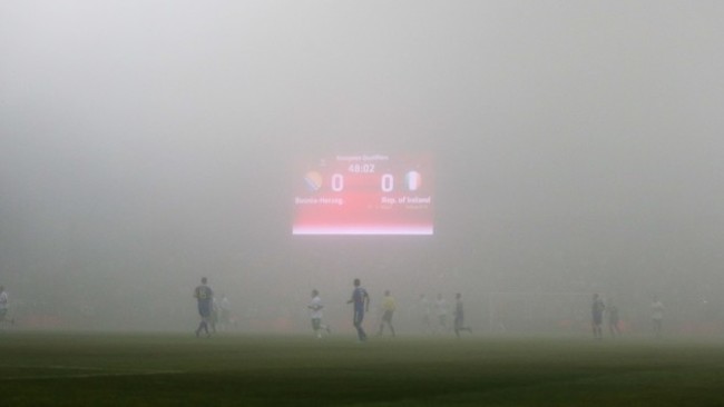 A view of the match as a thick fog covers the pitch