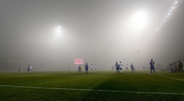 A view of the match as a thick fog covers the pitch