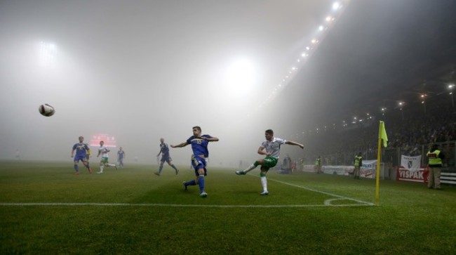Robbie Brady clears as a thick fog covers the pitch