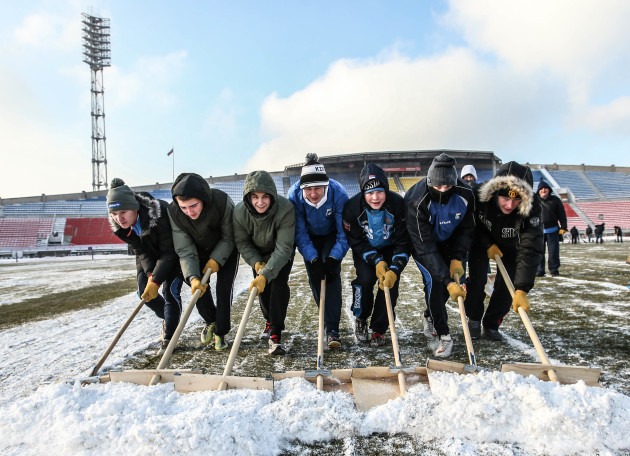 Snow is cleared form the pitch before the game