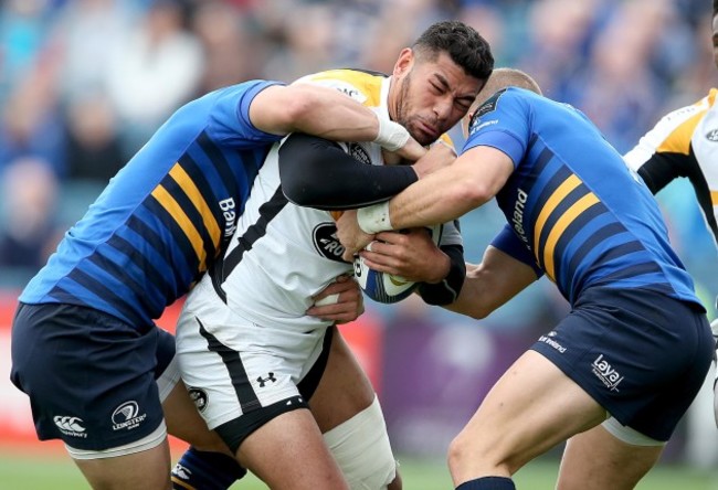 Ian Madigan and Fergus McFadden tackle Charles Piutau