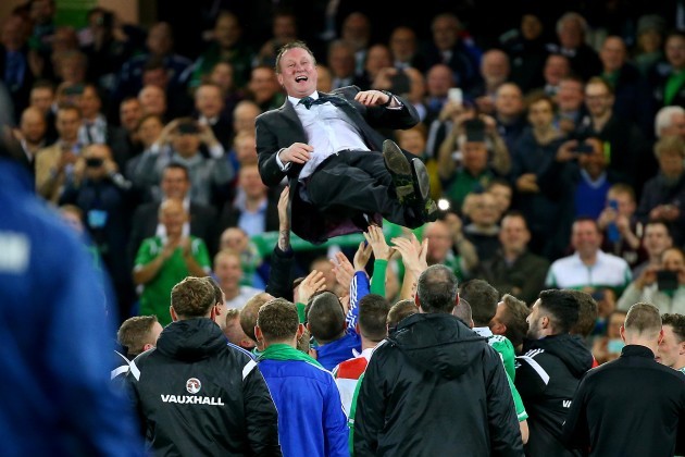 Michael O'Neill is congratulated by his team after they qualified for Euro 2016