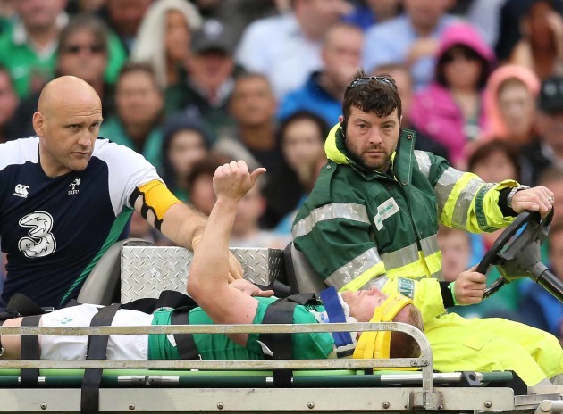 Keith Earls signals to the crowd as he goes off injured