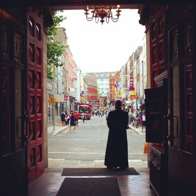 This priest keeps a watchful eye over his countrymen...