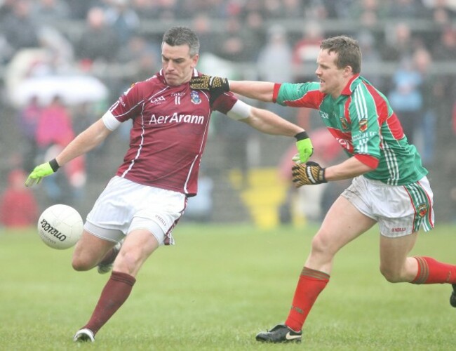 Padraic Joyce is tackled by Andy Moran