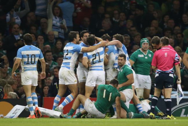 Argentina celebrate their third and decisive try as Dave Kearney and Rob Kearney look on