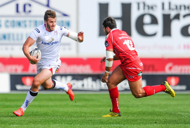 Stuart McCloskey evades the tackle of Gareth Owen