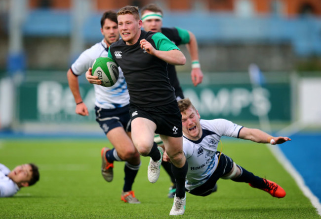 John Poland breaks past the tackle of Jack O'Sullivan