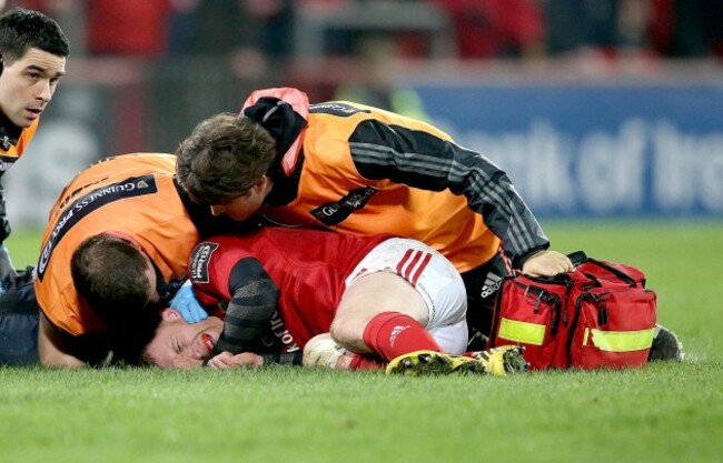 Keith Earls down injured after been tackled from Luke Fitzgerald and Zane Kirchner