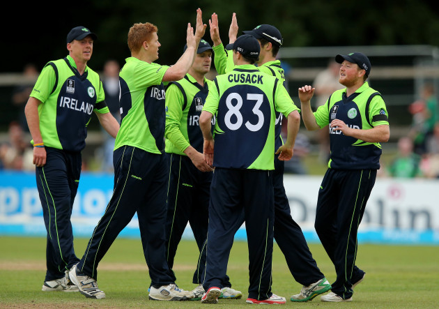 Kevin O'Brien celebrates taking a wicket with his teammates
