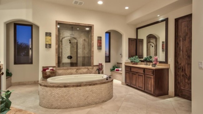 a-jacuzzi-tub-stands-in-the-center-of-the-master-bath